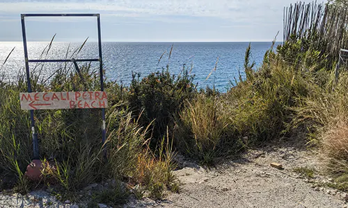 Sign at the parking of Kavalikefta Beach pointing to Megali Petra Beach